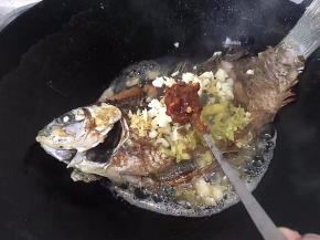 用勺子舀3勺豆瓣酱入锅