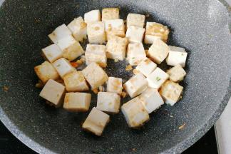 再下入豆腐块小火煎至两面金黄；