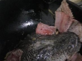 放入鱼头鱼骨和鱼尾爆油