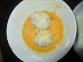 把搓圆的虾球放进鸡蛋液里打个滚