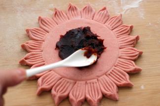 用勺子挖出豆沙、均匀涂抹在做好的面皮上