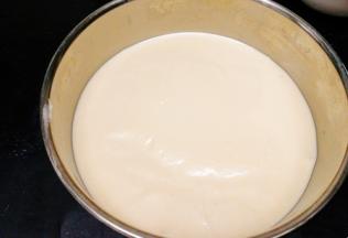 然后将模具在桌面上敲打几次将蛋糕糊中大的气泡震出