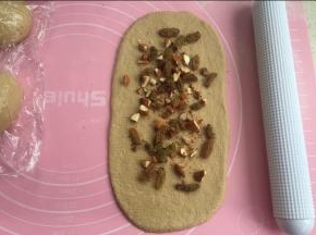 松弛下来的面团，擀开成椭圆形。铺适量馅料