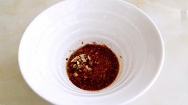 把烧热的油，用汤匙淋在辣椒粉上面出红油。