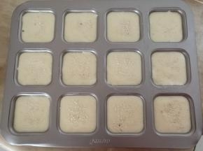 倒入模具中，震出大气泡，表面撒上少许芝麻。