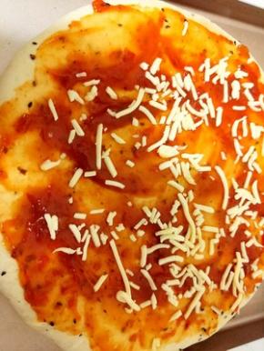 面饼上，先放一层披萨酱，再撒上一层，马苏里拉芝士！