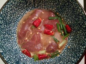 猪腰切开后，一定要片去猪腰上的“臊膜”，这点很重要，臊膜吃的会有怪味，用清水洗干净，再泡在调料里5分钟，清洗干净，切成花刀