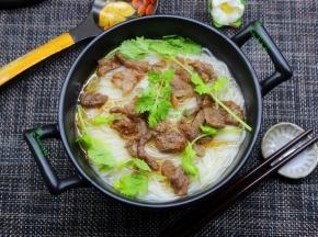 炒好的牛肉放入浓汤面上面，撒上香菜，即可；