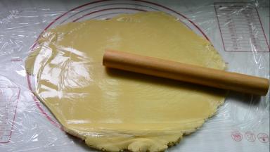 冷藏结束，放在保鲜膜中间擀开，擀成面饼