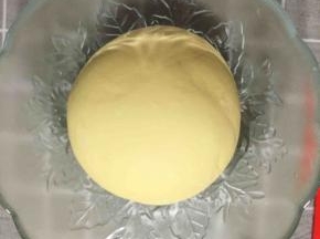 将面粉、酵母、白糖、南瓜泥混合揉成光滑的面团。