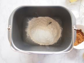 将面粉放入面包机桶中，在角落放入盐。