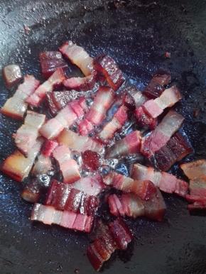 炒锅不放油，放入腊肉小火煸炒，煸出油脂