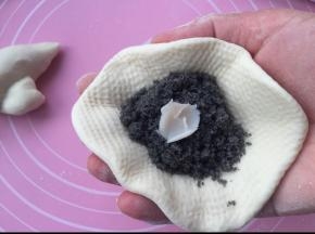 擀成圆片，放入10克芝麻馅和少许猪油。