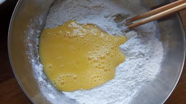 3．面粉中加入打散的蛋液和食用盐与白砂糖。