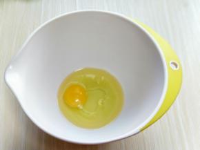 鸡蛋和玉米油放入器具中，用手动打蛋器打均匀。