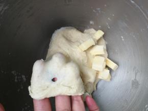 大约5分钟，和至面团能拉出粗膜，加入盐和软化的黄油，继续和面