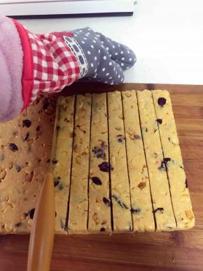 温热的时候拿一把快刀，左手戴手套，右手拿刀柄，快速的将糖切成均匀的长条，我切到最后两条时糖凉了，那叫一个难切啊，所以你们一定要在糖没有完全凉之前将糖快速切好