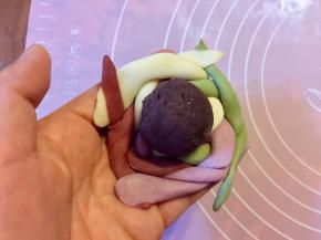 把编好的绣球皮翻面，把豆沙放中间。