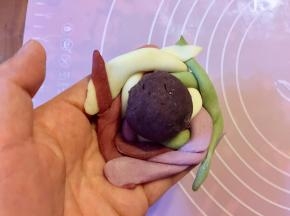 把编好的绣球皮翻面，把豆沙放中间。