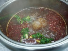 大火烧开，加麻辣锅底适量，烧开加点葱结，加一点点盐调味