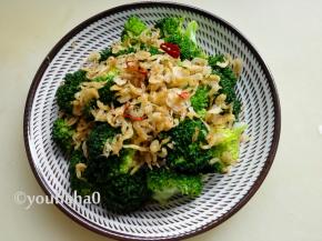 焯水后的西兰花中放入少许的生抽拌匀，装盘后将油炸的虾皮摆在上面即可，吃的时候拌匀