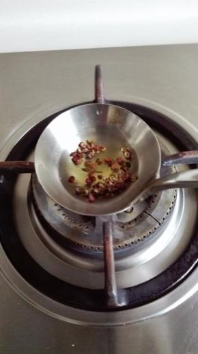 饭勺中放适量的植物油，放入花椒炸出香味