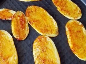 提示音响起，开盖，土豆片翻面，刷上调匀的辣椒酱