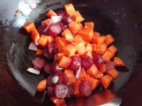 放入胡萝卜煸炒，至锅中的油带少许的红色为止；目的是让胡罗素溶于油脂中