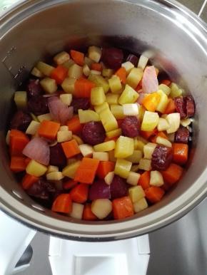 泡好的米放入锅中，把炒好的蔬菜铺在上面