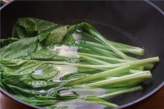 芥菜浸泡洗净，锅里烧开适量水，调入少量橄榄油，将芥菜焯熟后捞起，挤干水分