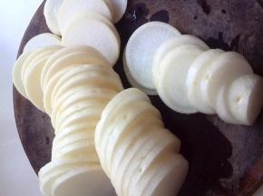 准备一个白萝卜，洗净去皮，切成0.5公分厚薄的圆片