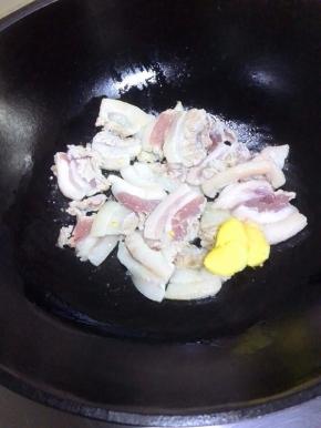 锅中放少许植物油，油五成热时，放入五花肉、姜片煸炒