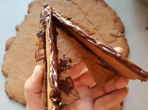 14．在房屋侧壁上涂融化后的巧克力，粘上后面的屋墙。