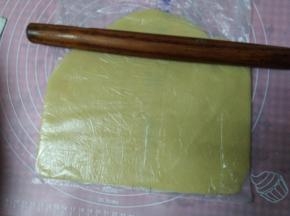 将面团放入保鲜袋中间擀开（也可以放在两张油纸中间，使面团不沾更好操作）用擀面杖擀开大约成0.3cm的薄片