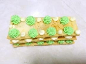 之后再盖上一片酥皮，挤上奶油霜