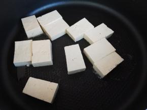 锅里放入少许食用油，把切好的豆腐块放进去煎一下