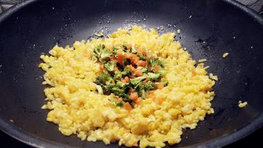 米粒炒至松散的状态后放入蔬菜翻炒。