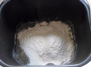 面包机桶里先放进鸡蛋液，再倒入墨汁水，放入除黄油外的所有材料