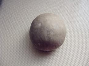 15分钟后，取一个面团压扁，再捏起来成球形