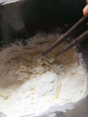 把所有材料，除黄油外，全部放入面包机桶中，用筷子稍微搅拌一下，以免机器开动时，面粉四处飞扬