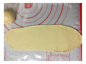 将面团排气，擀成椭圆形或长方形