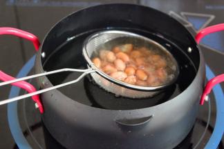 用油锅炸熟花生米，捞出沥干油；