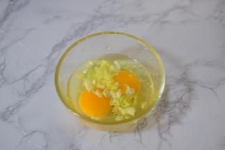 鸡蛋打入碗中，加葱花