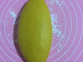 硅胶揉面垫上撒少许面粉，把黄色面团放在垫子上揉匀！
