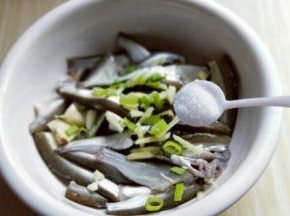 葱姜蒜去皮，切碎。洗干净的小鱼放入器具中，加入切好的葱姜蒜，再加入盐。