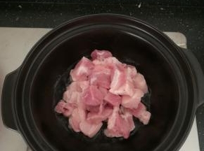 砂锅放油，加入肉块翻炒。