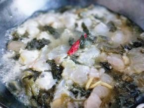 15分钟后将火转为大火，再次把锅烧沸。加入腌制好的鱼片，(用筷子夹去鱼片，切记不要一下子倒入锅中，动作要快，一片一片将鱼片夹入酸菜锅中)大火2-3分钟即可关火，调味出锅。