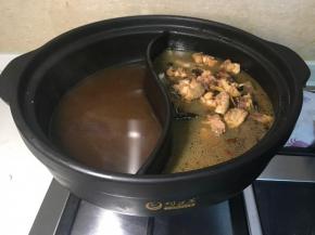 把鸡肉和油茶水分别倒入鸳鸯锅里。