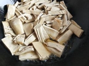 热锅入油放入豆腐皮煎香