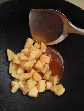 8、锅铲舀起糖浆能拉出直线来的时候关火，苹果下锅，翻炒几下，出锅。